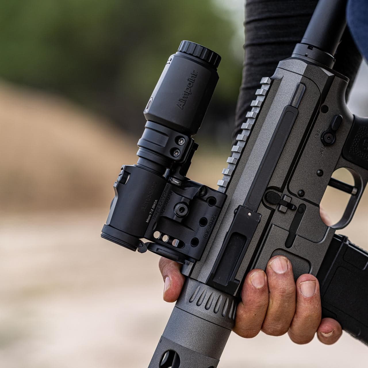 Micro T-2 and 3X-P magnifier on a rifle held outdoors