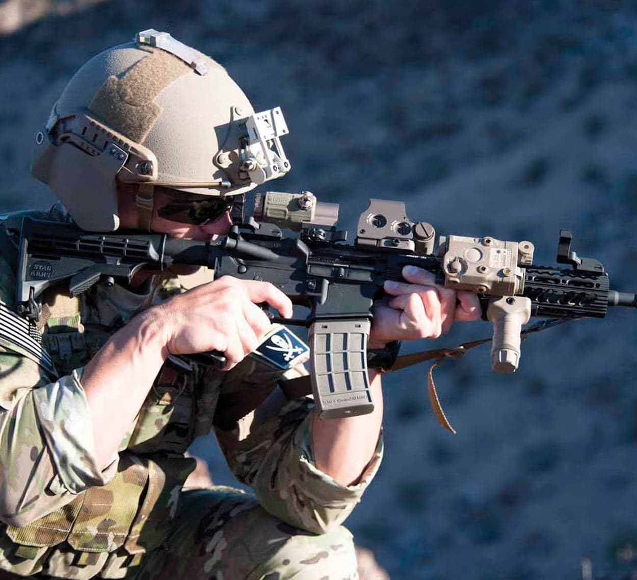 Soldier firing a rifle fitted with an ATPIAL in a desert setting