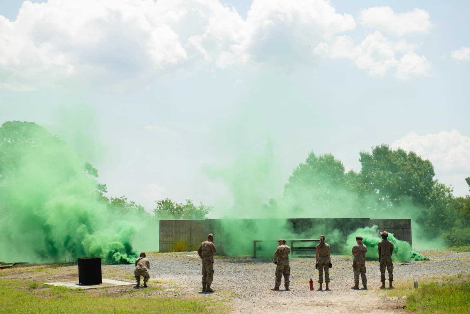 Airmen training with M18 green smoke grenades on a range