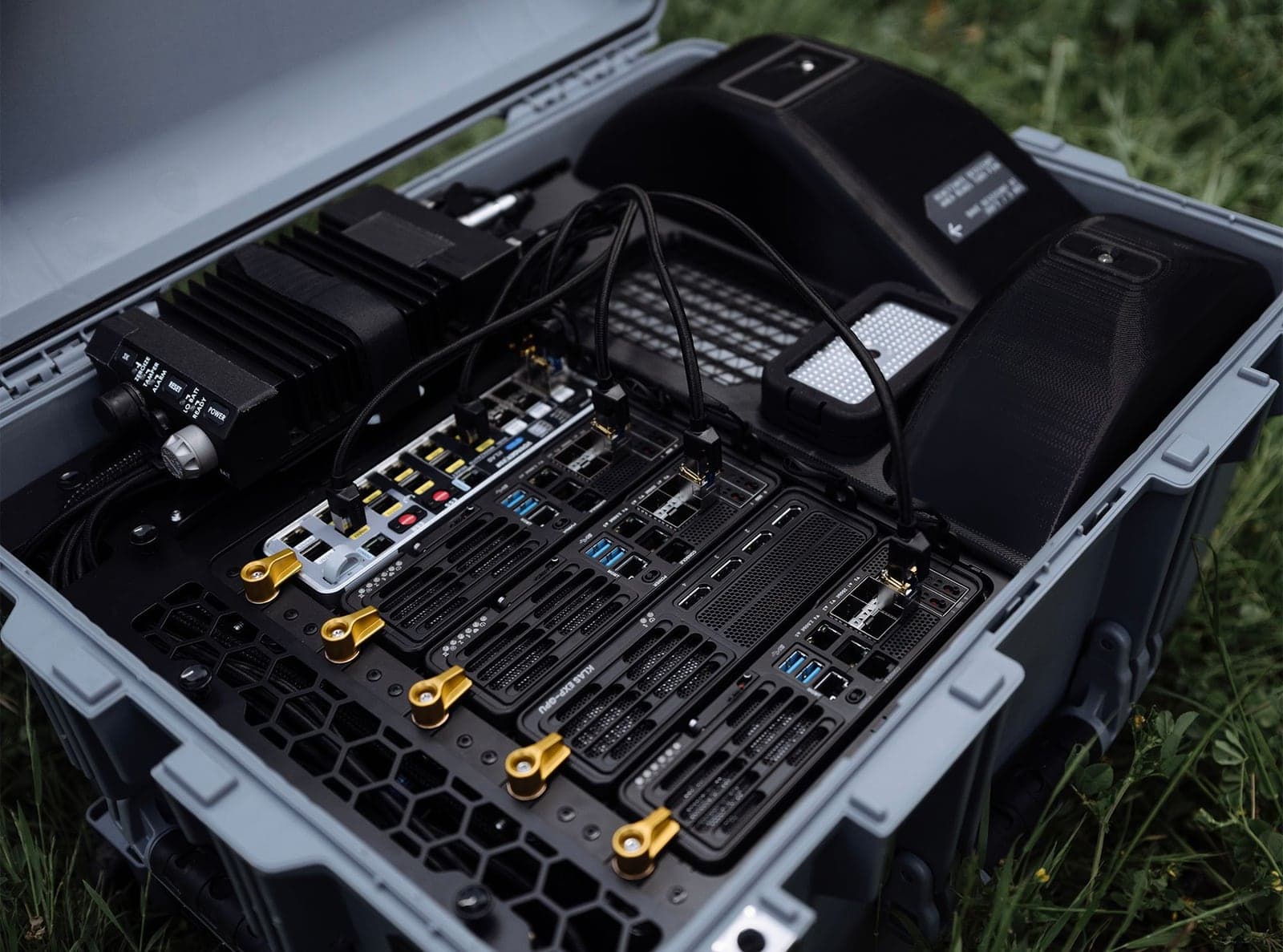 Overhead view of radio, control modules and networking hardware inside an open rugged case