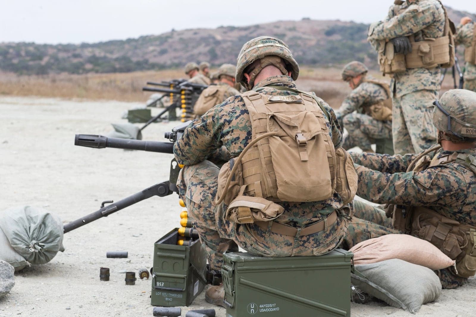 U.S. Marines firing tripod-mounted MK19 grenade machine guns on a range