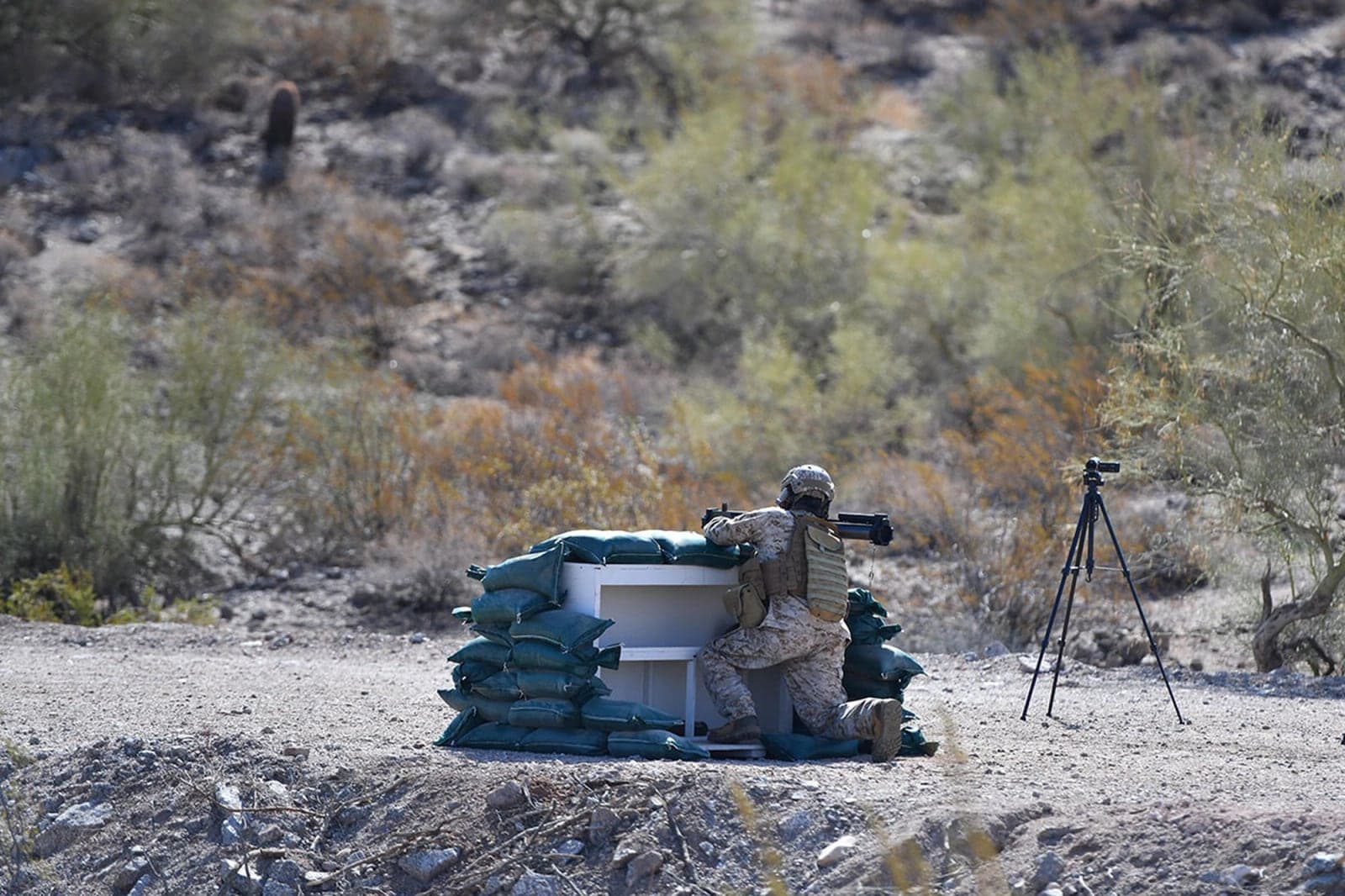 Test professional aiming an M72 LAW Fire from Enclosure test round from a sandbagged enclosure