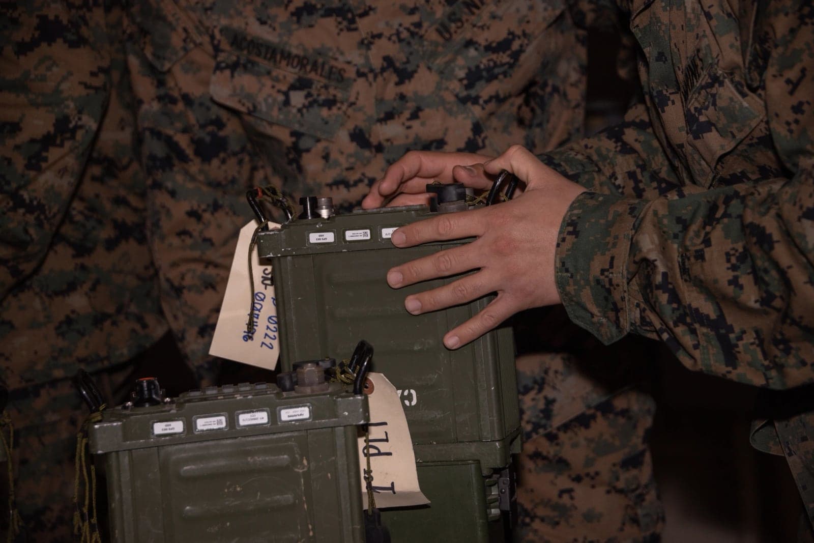Marines handling AN/PRC-160 radios during communications training on Camp Kinser