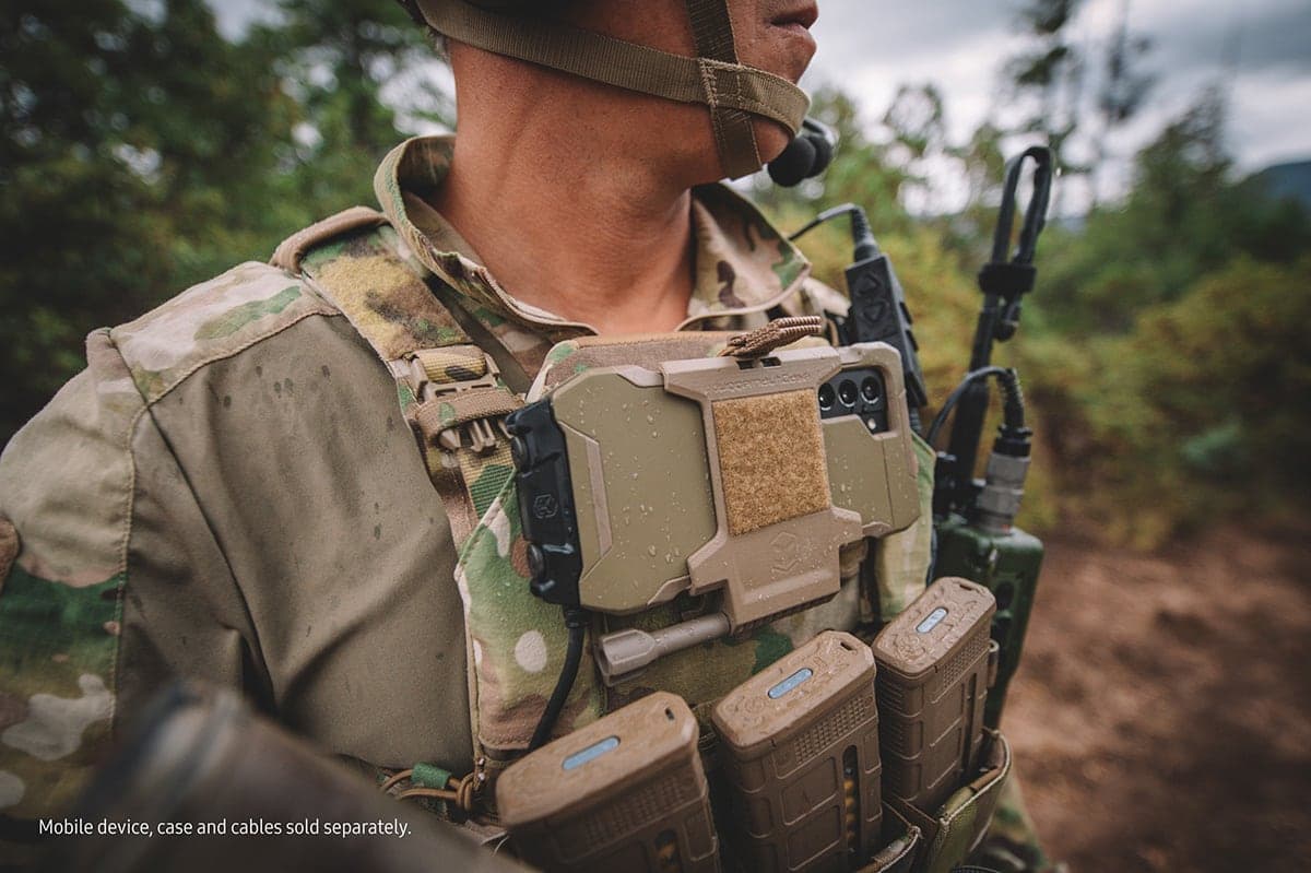 Soldier wearing a Tactical Edition phone in a chest mount on a plate carrier