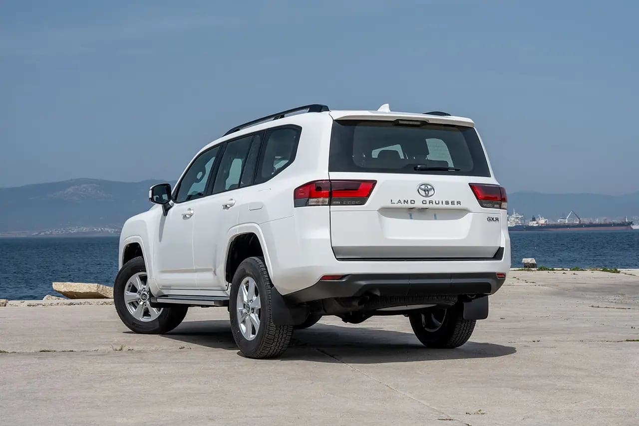 Rear three-quarter view of the Land Cruiser 300 by the sea