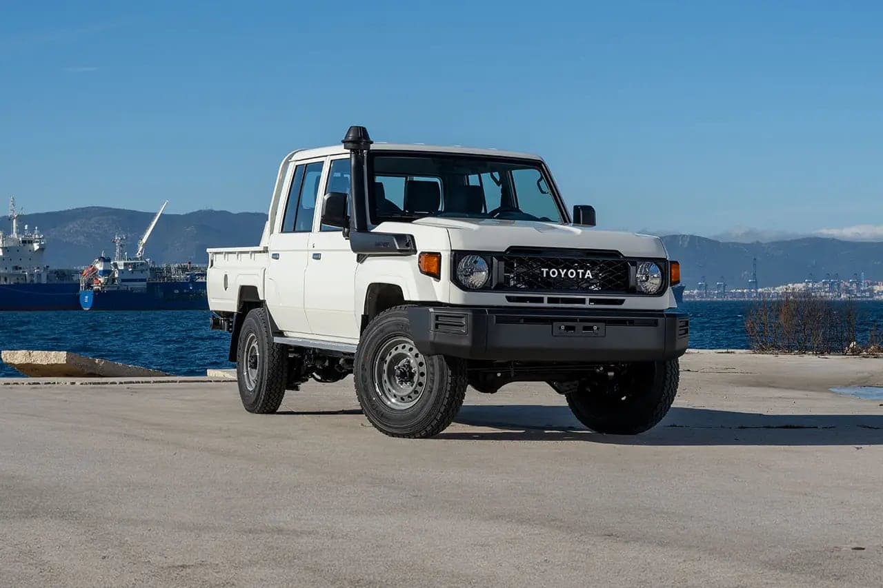 White Toyota Land Cruiser 79 double cab pickup with snorkel parked on a quayside