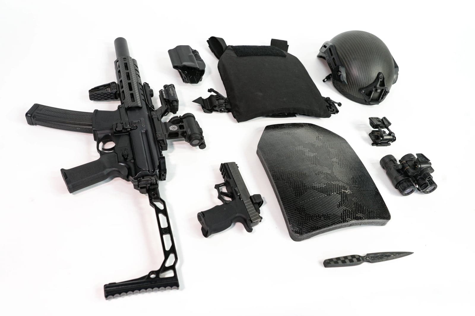 Plate shown with carrier, helmet, rifle and pistol on a white background